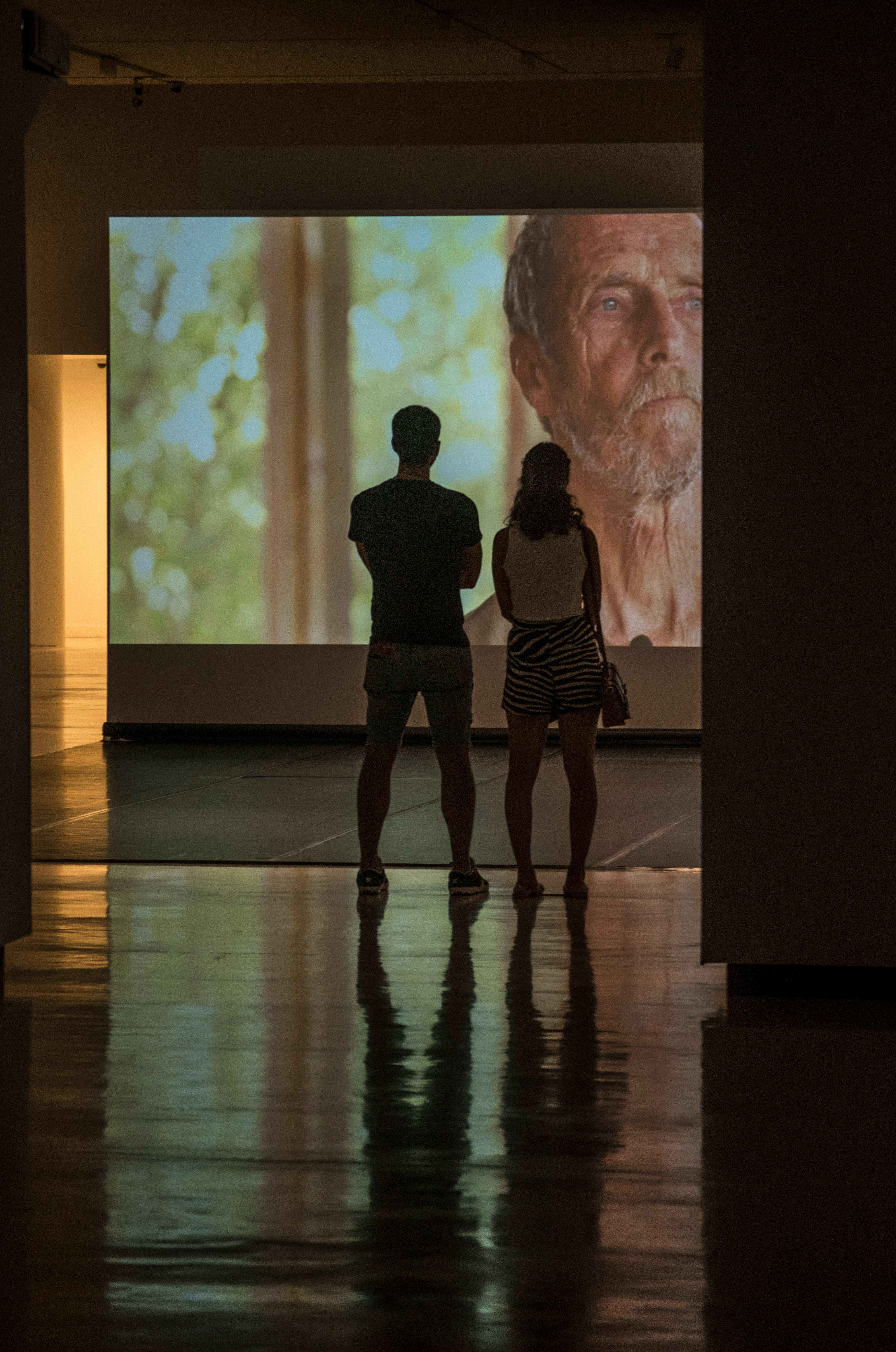 man and woman standing on brown wooden floor